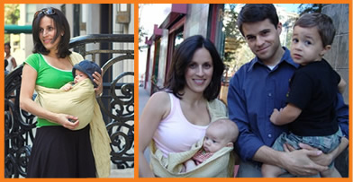 A smiling couple holding their two children in a city setting. The mother carries a baby in a light yellow Psling, while the father holds their toddler.