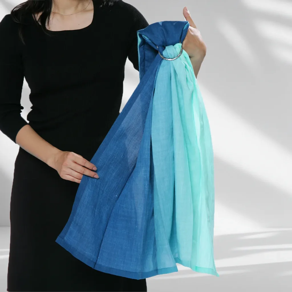 Hold the sling with both ring faces pointing forwards before putting it on