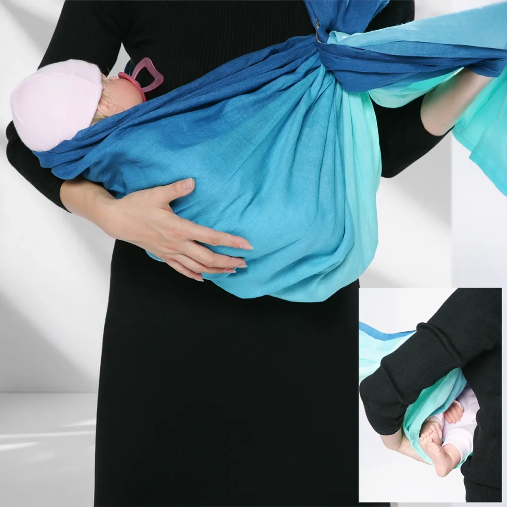 Side view showing the baby's feet visible beyond the edge of the cradle-carry pouch