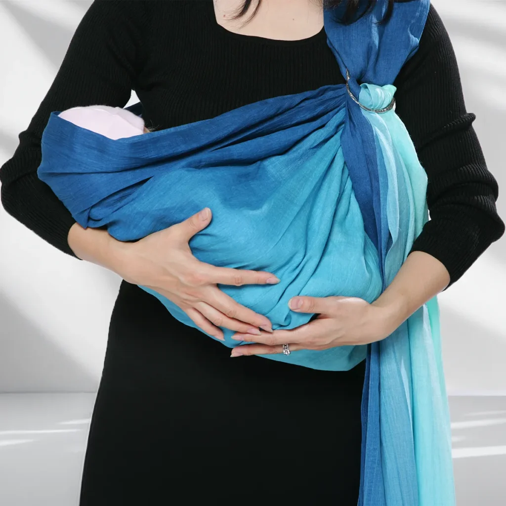 Front view while checking a baby supported in the PsLing cradle-carry position